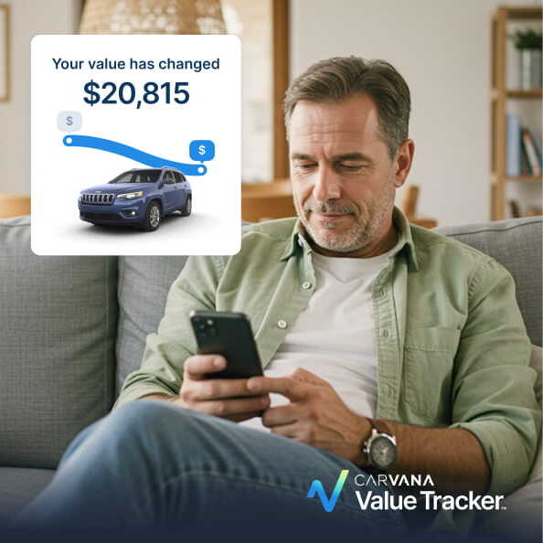 A man on a couch looking at his phone